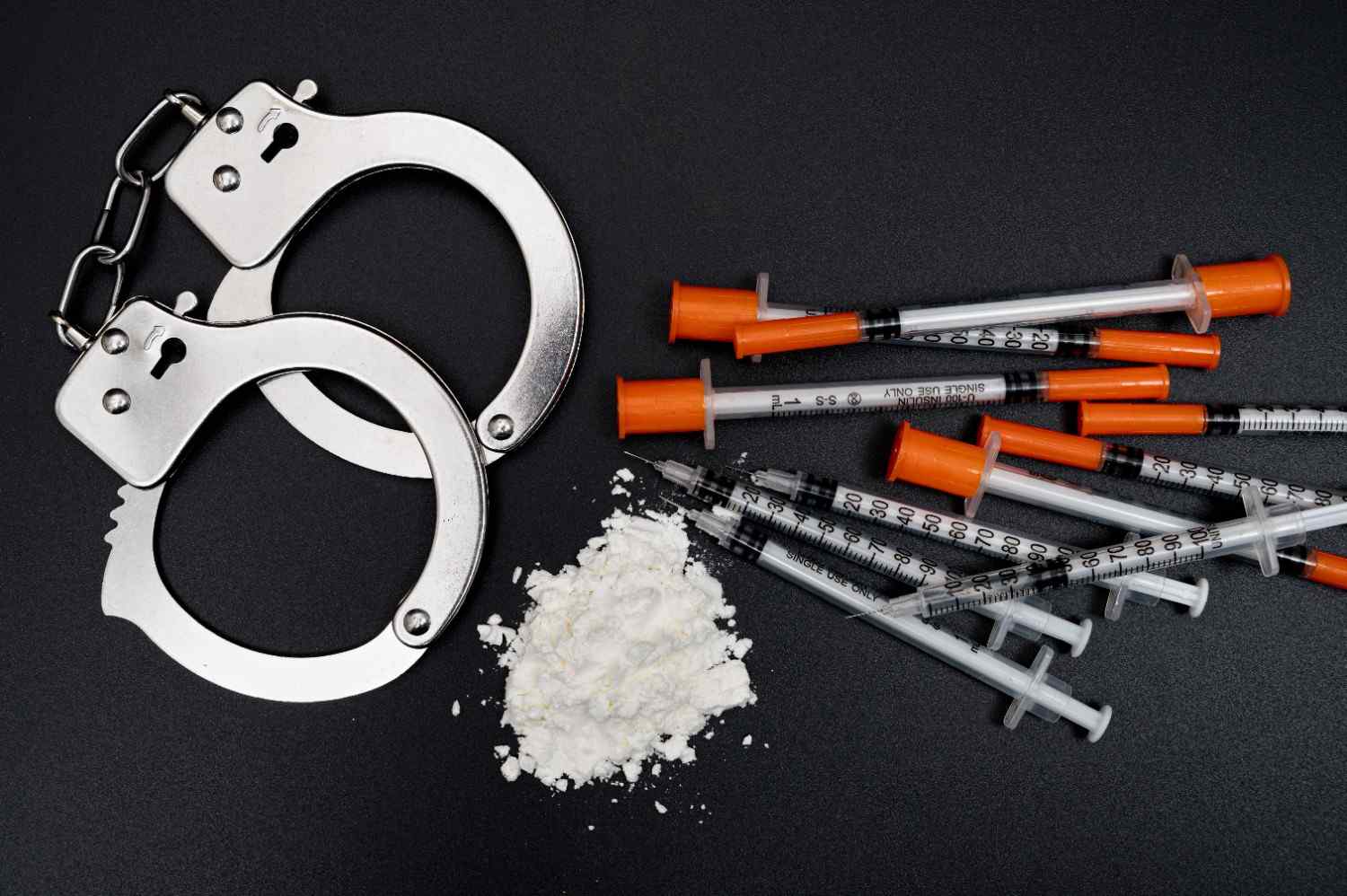drug-crime-concept-with-white-powder-disposable-syringe-black-background